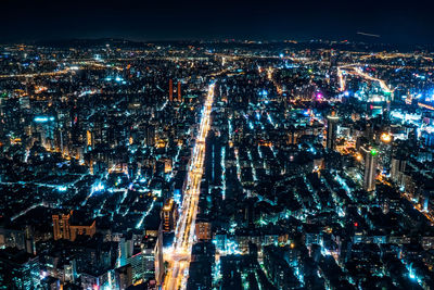 Aerial view of illuminated cityscape against sky at night