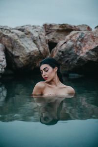 Woman on rock by sea