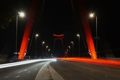 Illuminated bridge at night