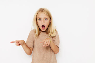 Portrait of young woman against white background