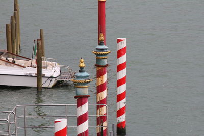 Sailboats moored in river, pillars in the water channel, venice