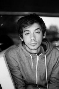 Portrait of young man sitting in car