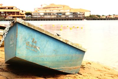 Boat moored at shore against sky