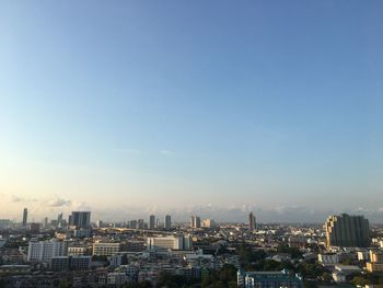 High angle view of buildings against blue sky