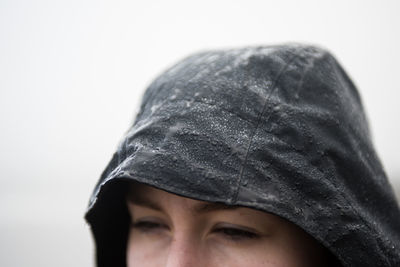 High section of woman with wet raincoat