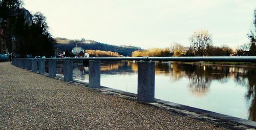 Footbridge over river against sky