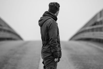 Man standing on road against clear sky