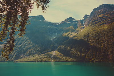 Scenic view of lake and mountains against sky