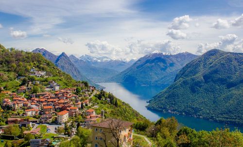 High angle view of townscape by mountains against sky