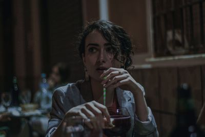 Portrait of a young woman drinking glass