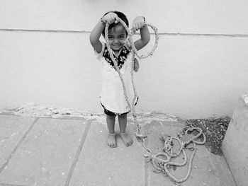 Portrait of girl standing on asphalt