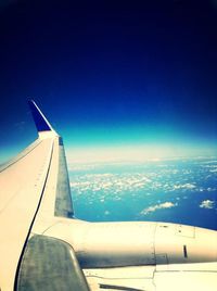 Cropped image of airplane wing over landscape