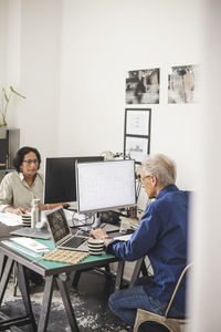 Female and male colleagues working on computer in office