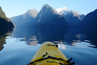 Scenic view of lake and mountains against clear sky