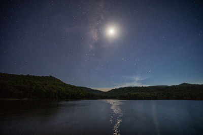 Scenic view of lake against sky at night