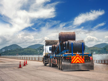 Truck receive steel wire rod from port to store at warehouse.