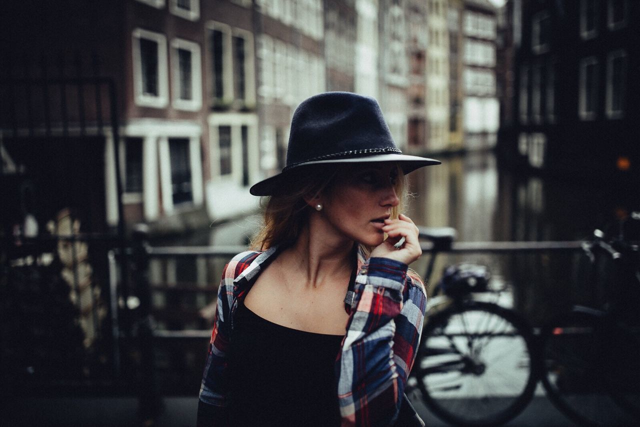 WOMAN STANDING ON CITY STREET