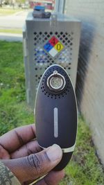 Cropped image of hand holding camera