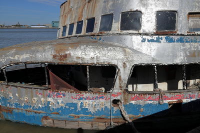 Abandoned boat against sea