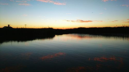 Scenic view of lake at sunset