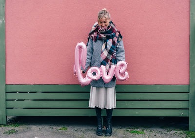 The concept of romantic relationship and love, date and joy. girl with inflated air letters love 