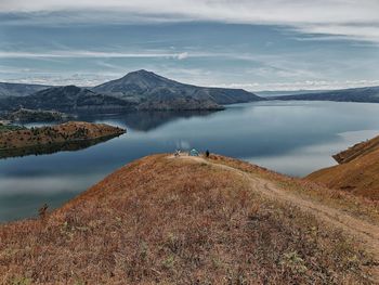 Scenic view of lake toba and mountains against sky at bukit holbung