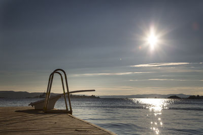 Diving platform on boardwalk by lake