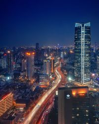 High angle view of illuminated buildings in city at night