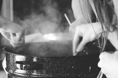 Cropped image of friends preparing food in utensil