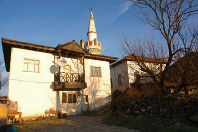 View of church and buildings against sky