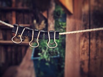 Close-up of clothespins hanging on clothesline