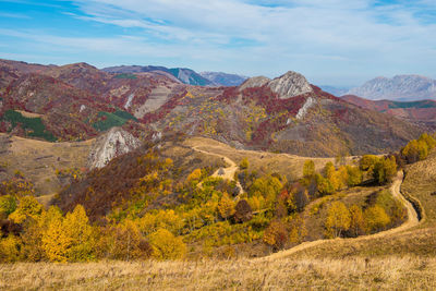 Scenic view of mountain range against cloudy sky