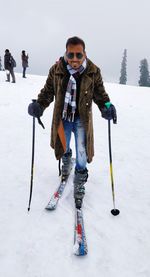 Full length of young man standing in snow