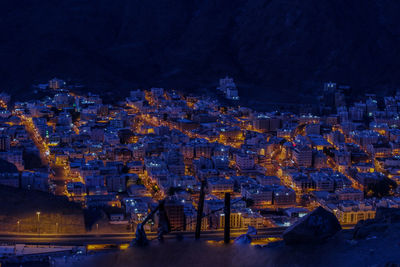 High angle view of illuminated buildings in city at night