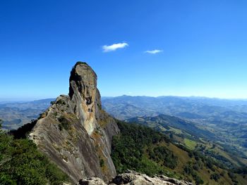 Scenic view of mountains against blue sky