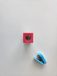 High angle view of information sign on table against white background