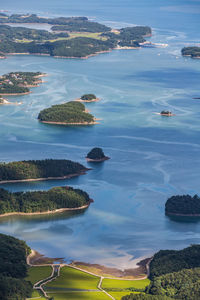 High angle view of cityscape by sea against sky
