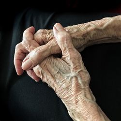 Close-up of man hand against black background