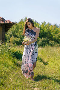 Young woman standing on field