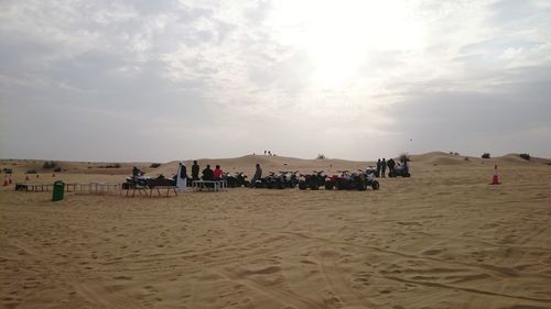 People on beach against sky