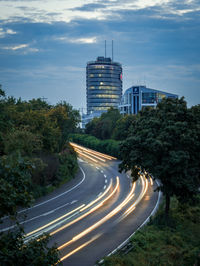 Road leading towards city against sky