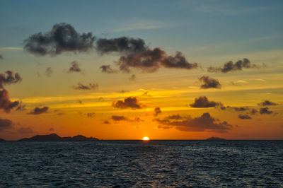 Wonderful sunset over the sea with island in silhouette