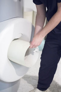 Midsection of man standing by mri scanner