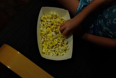 High angle view of woman holding salad in bowl