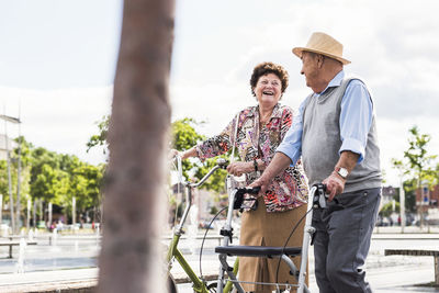 Senior couple with bicycle and wheeled walker