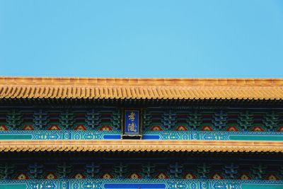 Low angle view of roof against clear blue sky