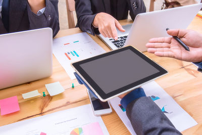 Low angle view of man using laptop on table