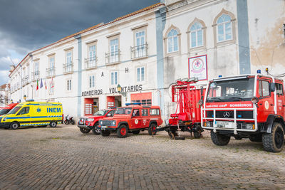 Cars on street against buildings in city