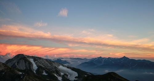 Scenic view of snowcapped mountains against sky during sunset
