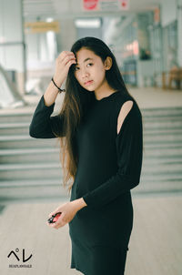 Beautiful young woman standing against a smiling